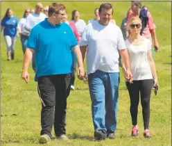  ??  ?? Members of the Robinson family, Dave Robinson, Denise Robinson and Austin Robinson, owners of Serenity Farm in Benedict, remembered their daughter Ashlee Robinson, who died due to a drug overdose, during the second annual Tri-County Memory Walk. At...