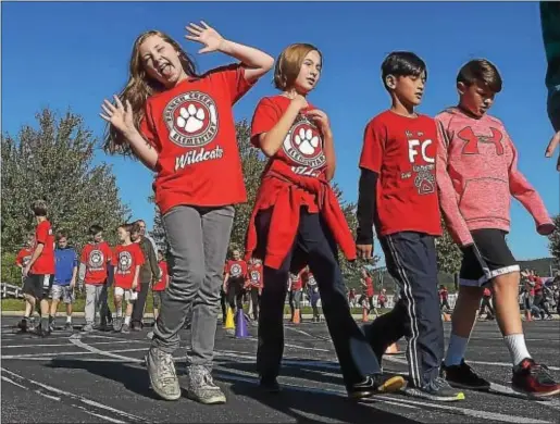  ?? PHOTOS BY PETE BANNAN-DIGITAL FIRST MEDIA ?? Students at French Creek Elementary School, above and below at left, take part in the school’s walkathon held on Oct. 18.