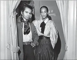  ?? THE NEW YORK TIMES ?? Karl Lagerfeld at Saks Fifth Avenue showing one of his snug-waisted styles, a silk taffeta skirt and blouse, in New York in 1976. Lagerfeld, 85, died Tuesday in Paris.