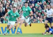  ?? Photo: AFP ?? Jack Crowley scores for Ireland in their 36-0 win against Italy.