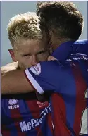  ??  ?? RECORD BREAKERS: Goal hero Connor Bell is hugged by Billy Mckay