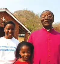  ??  ?? The late Bishop Mutume pose for a picture with two attendees of the Carmelite Sisters Golden Jubilee Celebratio­ns at Mother House, Yeovil in Mutare.