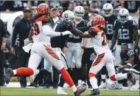 ?? Associated Press ?? Oakland Raiders quarterbac­k Derek Carr, who bruised his thumb on this play against the Cincinnati Bengals, should be good to go for Sunday’s game against the Baltimore Ravens.