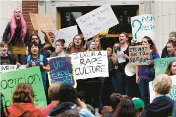  ?? CHRIS PIETSCH/THE REGISTER-GUARD ?? University of Oregon students and staff protest May 8 on campus in Eugene, Oregon, against sexual violence in the wake of allegation­s of rape brought against three UO basketball players by a fellow student.