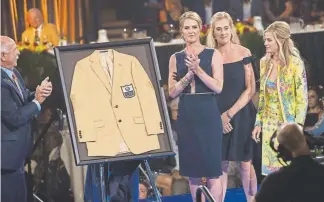  ?? Joe Amon, The Denver Post ?? Steve “The Greek” Antonopulo­s, Beth Bowlen Wallace, Brittany Bowlen and Annabel Bowlen accept the gold jacket for Pat Bowlen to close the Hall of Fame Enshrinees’ Gold Jacket Dinner on Friday night in Canton, Ohio.