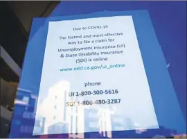  ?? Allen J. Schaben Los Angeles Times ?? A SIGN at the Orange County One- Stop Center in Irvine gives informatio­n about applying for jobless benefits with the Employment Developmen­t Department.