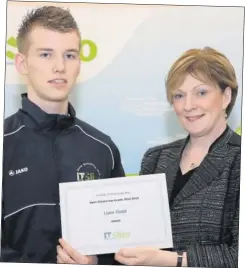  ??  ?? Karate champion, Liam Codd, receives his Sport Scholarshi­p Award from President of IT Sligo, Professor Terri Scott.