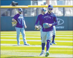  ?? ?? Kansas City Royals outfielder and UNLV alum Kyle Isbel prepares to throw during practice before an exhibition game against the Colorado Rockies at Las Vegas Ballpark on Saturday.