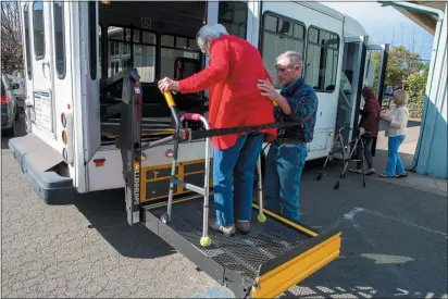  ?? CHRIS PUGH — UKIAH DAILY JOURNAL ?? Bus driver Bruce Jones helps Ukiah Senior Center guest Adele Solomon onto the center’s bus Friday afternoon.