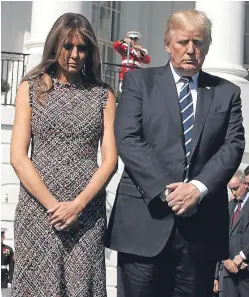  ??  ?? President Donald Trump and first lady Melania Trump lead a moment of silence for the victims of the shooting.