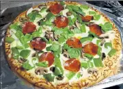  ?? LINDA GASSENHEIM­ER / TNS ?? White Pizza has a creamy, garlic sauce and is a nice change from tomato-based pizzas.