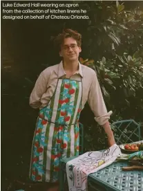  ?? ?? Luke Edward Hall wearing an apron from the collection of kitchen linens he designed on behalf of Chateau Orlando.