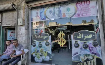  ?? — Reuters ?? A currency exchange shop displaying posters of dollar and Turkish lira is seen in the city of Azaz, Syria.