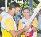  ??  ?? Libby Trickett passes the baton to Scott Sibson.