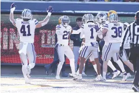  ?? (AP Photo/kathleen Batten) ?? Kansas State players celebrate after a defensive touchdown against West Virginia Saturday during the first half of an NCAA college football game in Morgantown, W.VA.