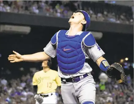  ?? Rick Scuteri Associated Press ?? WILL SMITH tracks a second-inning popup by Arizona’s Nick Ahmed before making the catch. The Dodgers lost 6-5 in 10 innings.