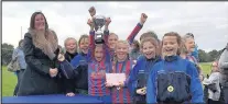  ??  ?? Emma Billington, head teacher of the Dixie Grammar Junior School and Nursery in Market Bosworth, presented a trophy to the winning girls’ team from Richmond Primary School in Hinckley