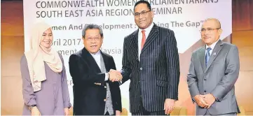  ??  ?? Pandikar (second left) shakes hands with Akhbar Khan during the Commonweal­th Women Parliament­arians South East Asia Regional Seminar. Also present are Dr Noraini and Deputy Speaker Datuk Seri Ronald Kiandee. (right). — Bernama photo