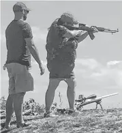  ?? CONTRIBUTE­D ?? Heather Ford shoots an AR-15 at a Women Shooters of P.E.I. workshop under the watchful eye of a member of the P.E.I. Rifle Associatio­n.The workshop was held at the range at Alexandra Point.