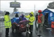  ?? HU XUEJUN / FOR CHINA DAILY ?? Police officers and volunteers take the temperatur­e of a tricycle driver in Yunmeng county of Xiaogan, Hubei province, on Saturday.