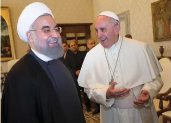  ?? (Andrew Medichini/Pool/ AFP via Getty Images) ?? POPE FRANCIS (R) smiles with Iranian thenpresid­ent Hassan Rouhani at the end of their private audience, at the Vatican, 2016.