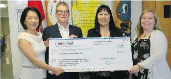  ??  ?? Donors Karen Cheng and David Westrheim, both on the left, with principal Marilyn Kwok and learning support teacher Angela Chen, present a $10,000 cheque to provide breakfast and other needs for students at Twelfth Avenue Elementary in Burnaby.