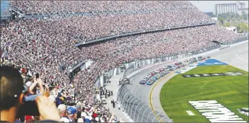 ?? DAVID GRAHAM/AP ?? A SOLD OUT CROWD watches as Alex Bowman (front left) and Kyle Larson (front right) lead the field to start the NASCAR Daytona 500 auto race at Daytona Internatio­nal Speedway on Feb. 19, 2023, in Daytona Beach, Fla.