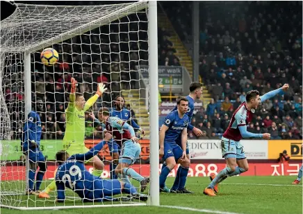  ?? PHOTO: AP ?? Chris Wood of Burnley, nearest the goalkeeper, scores his side’s winning goal during their Premier League victory over Everton.