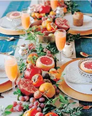  ?? DANAE HORST for Jungalow ?? A HOLIDAY tablescape featuring pomegranat­es, grapefruit and greenery by Jungalow
|