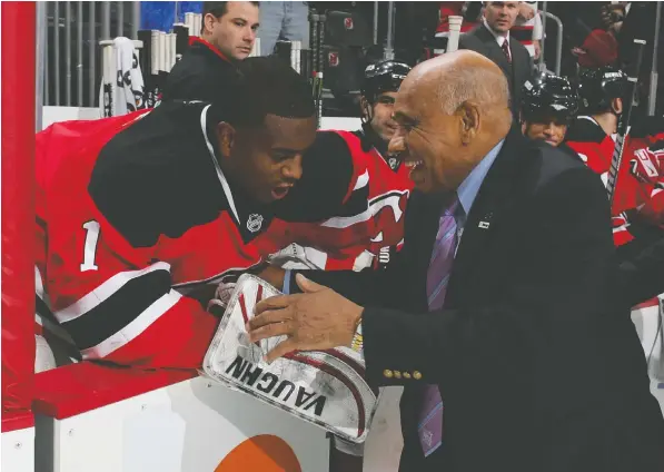  ?? — GETTY IMAGES / FILE ?? Willie O’Ree, right, the first black player in the NHL, speaks to Kevin Weekes in 2009, when he was with the New Jersey Devils.