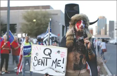  ?? (File Photo/AP/Dario Lopez-Mills ) ?? Jacob Anthony Chansley, who also goes by the name Jake Angeli, a QAnon believer, speaks Nov. 5 to a crowd of President Donald Trump supporters outside the Maricopa County Recorder’s Office where votes in the general election were being counted in Phoenix. Some followers of the QAnon conspiracy theory are now turning to online support groups and even therapy to help them move on, now that it’s clear Trump’s presidency is over.