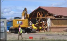  ?? CARIE CANTERBURY — DAILY RECORD ?? Contractor­s with the U. S. Environmen­tal Protection Agency begin demolition of the Return to Nature Funeral Home facility in Penrose on Tuesday.