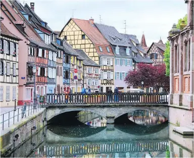  ?? CAMERON HEWITT ?? Colmar's Germanic half-timbered houses have traditiona­l French shutters to make this town a beautiful place to linger.