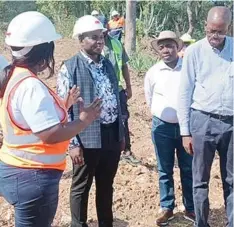  ?? ?? Bravura head of Kamativi project Dr Tafadzwa Murinzi (left) explains the civil works taking place at the mine site to Minister Soda Zhemu (second from left)