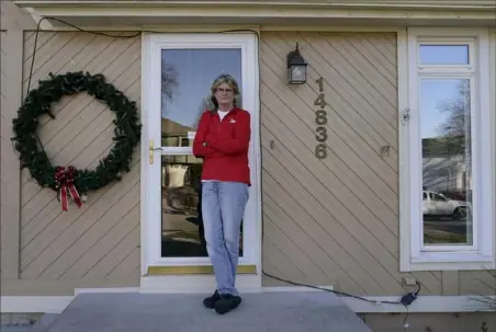  ?? Charlie Riedel/Associated Press ?? Keli Paaske stands outside her home Friday in Olathe, Kan. Ms. Paaske was laid off in August from a company supplying fire doors to hospitals after being furloughed for five months and has struggled to find a new job.