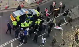  ?? Photograph: Conor Noon/PA ?? Officers use a police vehicle to escort Keir Starmer to safety after the Labour leader was surrounded by protesters on Monday.