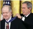  ?? THE ASSOCIATED PRESS FILE PHOTO ?? Poet and historian Robert Conquest receives the Presidenti­al Medal of Freedom from George W. Bush in 2005. Conquest has died, age 98.