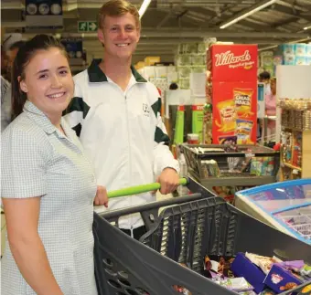 ??  ?? Anja Oelofsen, with the help of Ross Stanley, won the 1-minute dash, but had no problem in filling her trolley with goodies to the value of more than R6 000! Some for herself, some on mom Noeleen’s instructio­n, and some for charity.