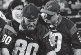  ?? Brett Coomer / Staff photograph­er ?? Texans fans embrace as time runs out in the fourth quarter, cementing a Colts win.