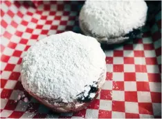  ??  ?? A couple of vegan paczkis are ready for eating Monday at the Little Foot Foods restaurant. Owner Jordynne Ropat deep fries her paczki in sunflower oil and adds fillings. Her regular yeast-risen doughnut recipe doesn’t have eggs, butter or milk and she uses a little vegan margarine.