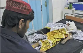  ??  ?? ABDUL KHALIQ/AP An injured boy receives treatment at a hospital after US airstrikes in Helmand Province, in southern Afghanista­n, on November 28, 2018.