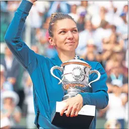  ??  ?? Simona Halep celebrates her French Open success yesterday