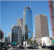  ?? Jae C. Hong / Associated Press ?? The Wilshire Grand Center features a 100-foot-tall sail-shaped glass and steel crown. It is the first modern high-rise in Los Angeles without a flat roof.