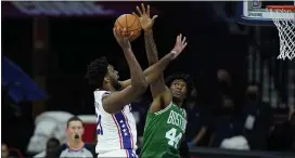  ?? MATT SLOCUM — THE ASSOCIATED PRESS ?? 76ers center Joel Embiid, left, goes up for a shot against the Celtics’ Robert Williams III Tuesday. Embiid scored 18 points in 17 minutes as the Sixers won their preseason opener, 108-99.