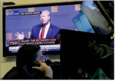  ?? AP/RICHARD DREW Article,2D ?? A television screen at the New York Stock Exchange shows President Donald Trump’s speech Tuesday at the Economic Club of New York, but his comments caused little reaction in the stock market.