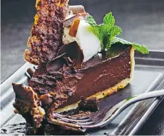  ??  ?? Bar Oso’s Valrhona chocolate tart is a terrific dessert choice.