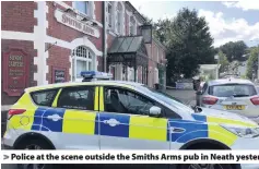  ??  ?? > Police at the scene outside the Smiths Arms pub in Neath yesterday. Right: Mark Winchcombe