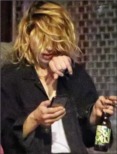  ??  ?? Worse for wear: Billie Piper emerges from a bar in Camden, north London, clutching a bottle