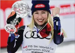  ?? AP ?? United States’ Mikaela Shiffrin holds up the trophy Saturday for the alpine ski, women’s World Cup slalom discipline, in Saalbach, Austria. Shiffrin came back from a knee injury earlier in the season for her 97th overall World Cup win.