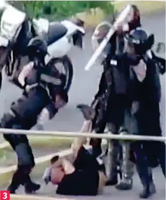  ??  ?? Sickening: A riot shield is smashed against his head as he curls up on ground